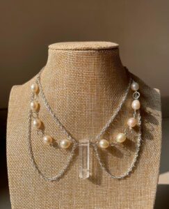 Elegant pearl necklace displayed on a mannequin for necklace length guide.