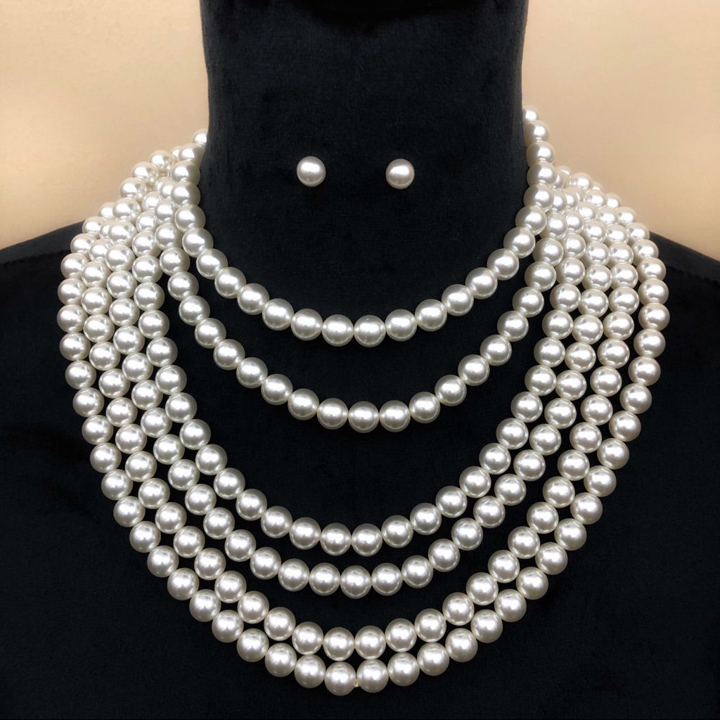 “Display mannequin adorned with layered handmade silver-beaded necklaces and matching stud earrings, showcasing affordable luxury jewelry in multiple lengths.”