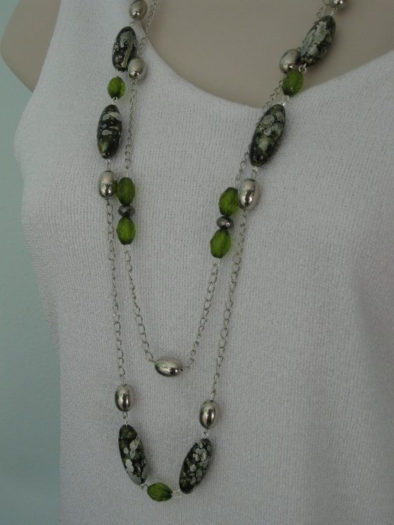 “Close-up of layered silver beaded necklaces showcasing different bead shapes, used to illustrate styling ideas for silver beaded jewelry.”